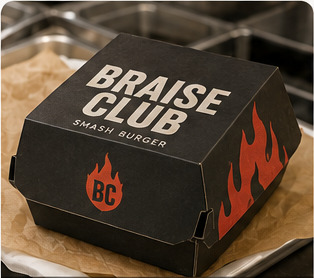Braise Club branded burger box in a fast-food restaurant